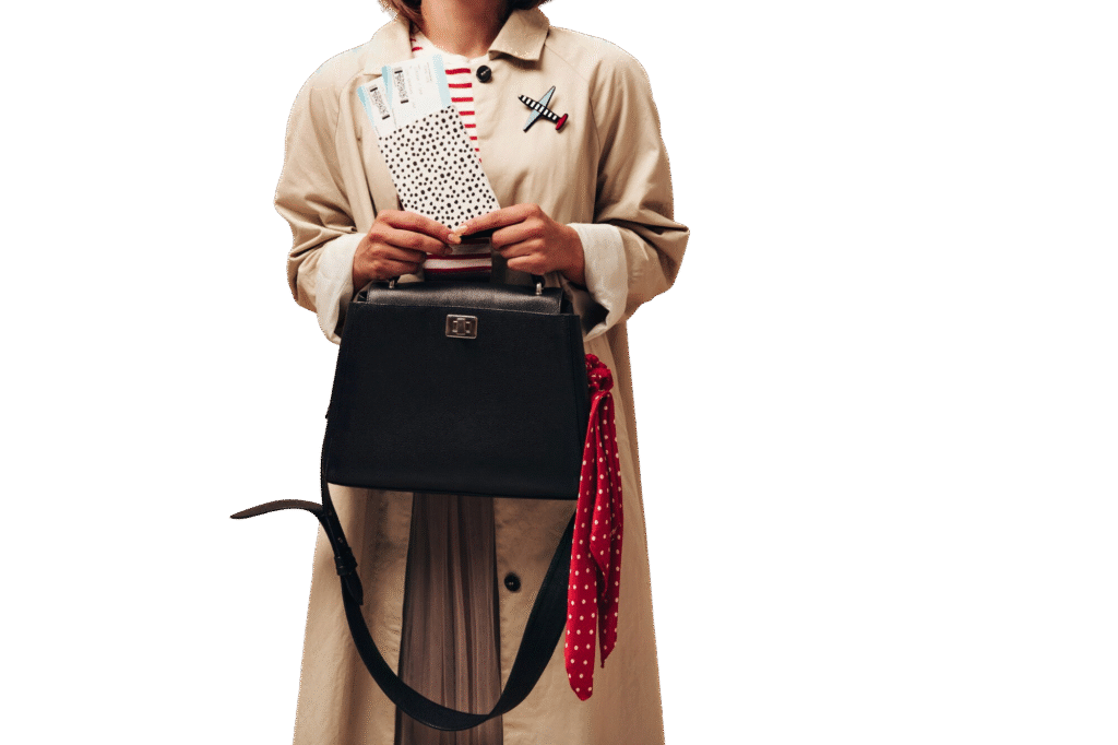 stylish woman long autumn coat modern striped sweater holds black handbag tickets isolated beige background